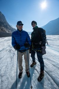Joseph and Ranulph Fiennes stand on the Athabasca Glacier.  Sir Ranulph Fiennes, "the greatest living explorer," and his cousin, actor Joseph Fiennes, revisit Ran’s 1971 expedition of Canada’s British Columbia.