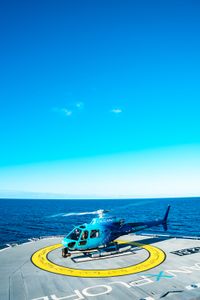 The OceanXplorer helicopter takes off from the ship. (National Geographic/Patrick Hopkins)