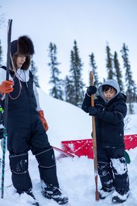 Ricko DeWilde teaches his son Keenan DeWilde how to properly set a beaver trap under the ice. (BBC Studios Reality Productions/v)