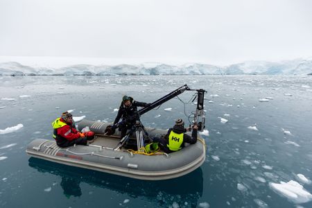 Crew preparing the specialized underwater filming rig mounted to a small RIB. (National Geographic for Disney/Holly Harrison)