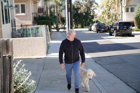 Cesar approaches Alex and Thomas' residence with a new dog. (National Geographic)