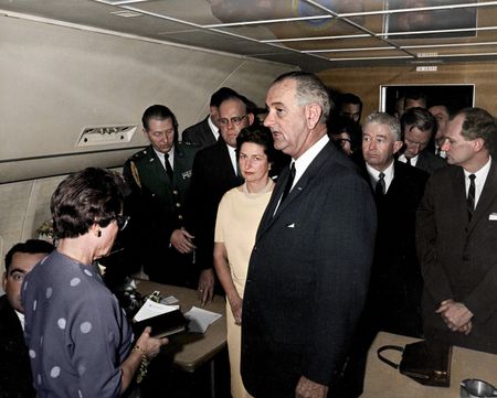 (ST-1A-2-63) This colorized archival image shows the swearing-in ceremony of Lyndon B. Johnson (LBJ) as President aboard Air Force One, Nov. 22, 1963, in Dallas. (Cecil Stoughton/White House Photographs/John F. Kennedy Presidential Library and Museum, Boston)
