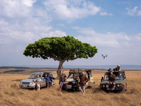 From left: Driver/Spotter Lisa Blackwell, Camera Operator Manu Akatsa, Driver Pete Blackwell, Camera Operator Russell MacLaughlin, Sequence Field Director Charlie Luckock, and Drone Pilot Barny Trevelyan-Johnson behind-the-scenes of Incredible Animal Journeys in Maasai Mara, Kenya. (National Geographic for Disney/David Chancellor)