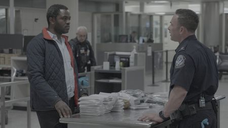 Chief Augustino questions a courier about the numerous amount of electronic devices found in their belongings in Dulles, Va. (National Geographic)