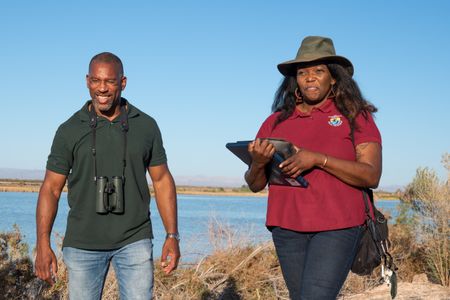 Alicia Thomas, a wildlife biologist for the U.S. Fish and Wildlife Service, takes a walk with Christian Cooper at the Sonny Bono Salton Sea National Wildlife Refuge, CA. She explains that most of the managed ponds were man made and they were created specifically for providing bird habitats. (National Geographic/Jon Kroll)
