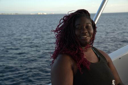 Shark scientist Jasmin Graham smiles on a boat before taking Anthony Mackie swimming with sharks. (National Geographic/Lisa Tanner)