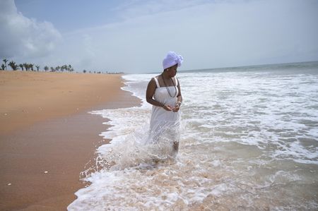 Delisha Marshall stands reverently on Ouidah Beach, where her ancestor, Peter 'Gumpa' Lee, was taken in 1860. (National Geographic/Etinosa Yvonne)