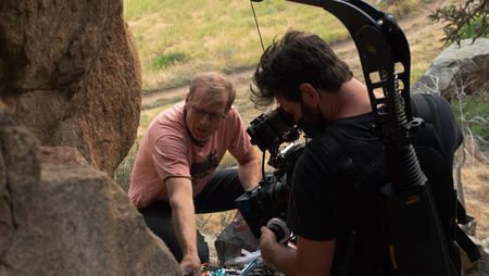Conrad Anker unpacks his climbing bag while cinematographer Nick Kraus films him.  (National Geographic/Elena Gaby)