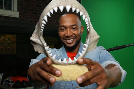 Keon Poole's face inside of a display shark jaw. (National Geographic/Robert Toth)