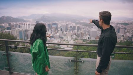 Awkwafina and Antoni Porowski look out at Namsan viewpoint. (National Geographic)