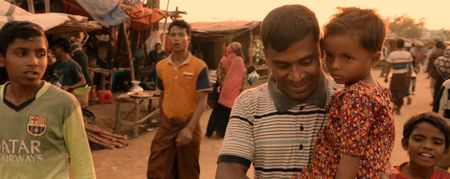 Kamal Hussein holds Dokana, a lost girl, in the Kutupalong Refugee Camp. When 700,000 new refugees fled from Myanmar to Bangladesh in 2017, Kamal took it upon himself to start a "Lost and Found" booth to reunite families in the camp who had been torn apart by the chaos. Lost and Found, directed by Academy Award winner Orlando von Einsiedel (“The White Helmets”, “Virunga"), is an inspiring story of humanity and heroism in the world’s largest refugee camp, that follows Kamal Hussein, a Rohingya refugee who has dedicated his life to reuniting children with their parents. (Nobel Media/Franklin Dow)