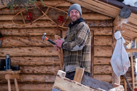 Johnny Rolfe builds his dog Java a box seat that will attach to his sled.  (BBC Studios Reality Production/Patrick Henderson)