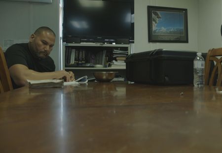 A CBP Agent is reading a report in an office in Mayaguez, PR. (Lucky 8 TV)