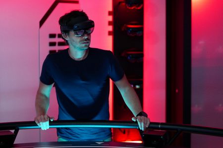 Eric Stackpole wears hololens glasses in the Hololab on the OceanXplorer. (National Geographic/Mario Tadinac)