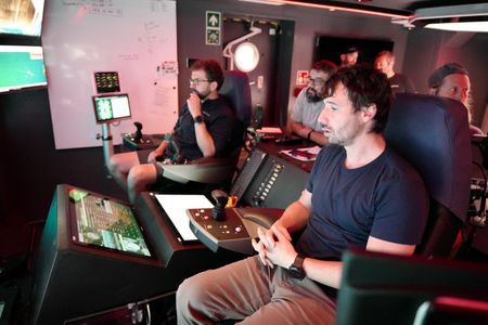 Erick Stackpole and crew take note of images from the ROV control room. (National Geographic/Mario Tadinac)