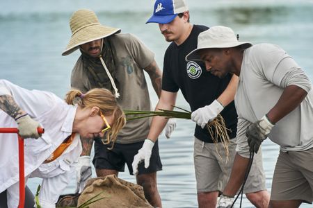 Anthony Mackie and CRCL volunteers on the banks of the Violet Canal prepping sea grass. From L-R: Jessica Converse, Brendon Bourg, Chief Devon Parfait, Anthony Mackie. (National Geographic/Brian Roedel)