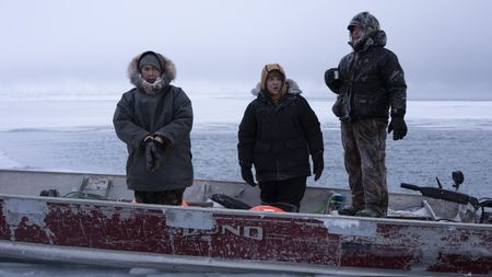 Daniel , Nalu and Ala Apassingok search for seals in the ice covered sea. (National Geographic/Zach Clanton)