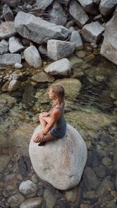 Angel Collinson meditates on a creek.   (National Geographic/Elena Gaby)