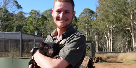 Tyler holding a tasmanian devil baby. (Big Wave Productions)