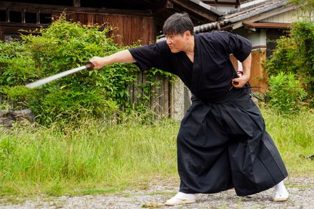 Isao Machii cuts a BB pellet in half with a katana.  (National Geographic/Dana Hayes)